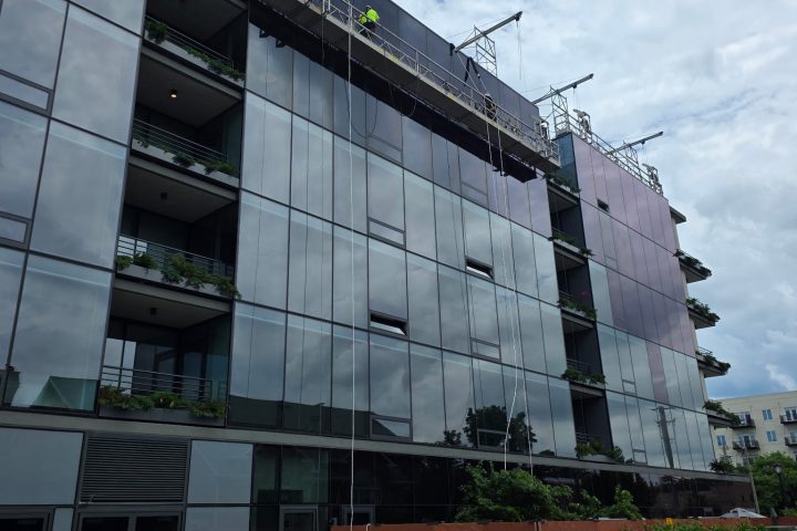 Commercial window film being applied to a glass building in Wauconda IL by Sullivan's Window Tinting